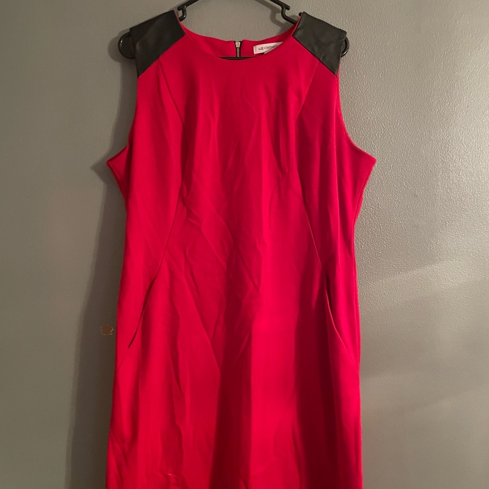Red with leather arm details and a gold zipper.